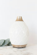 Emberna White Edition humidifier with soft flame glow and mist
