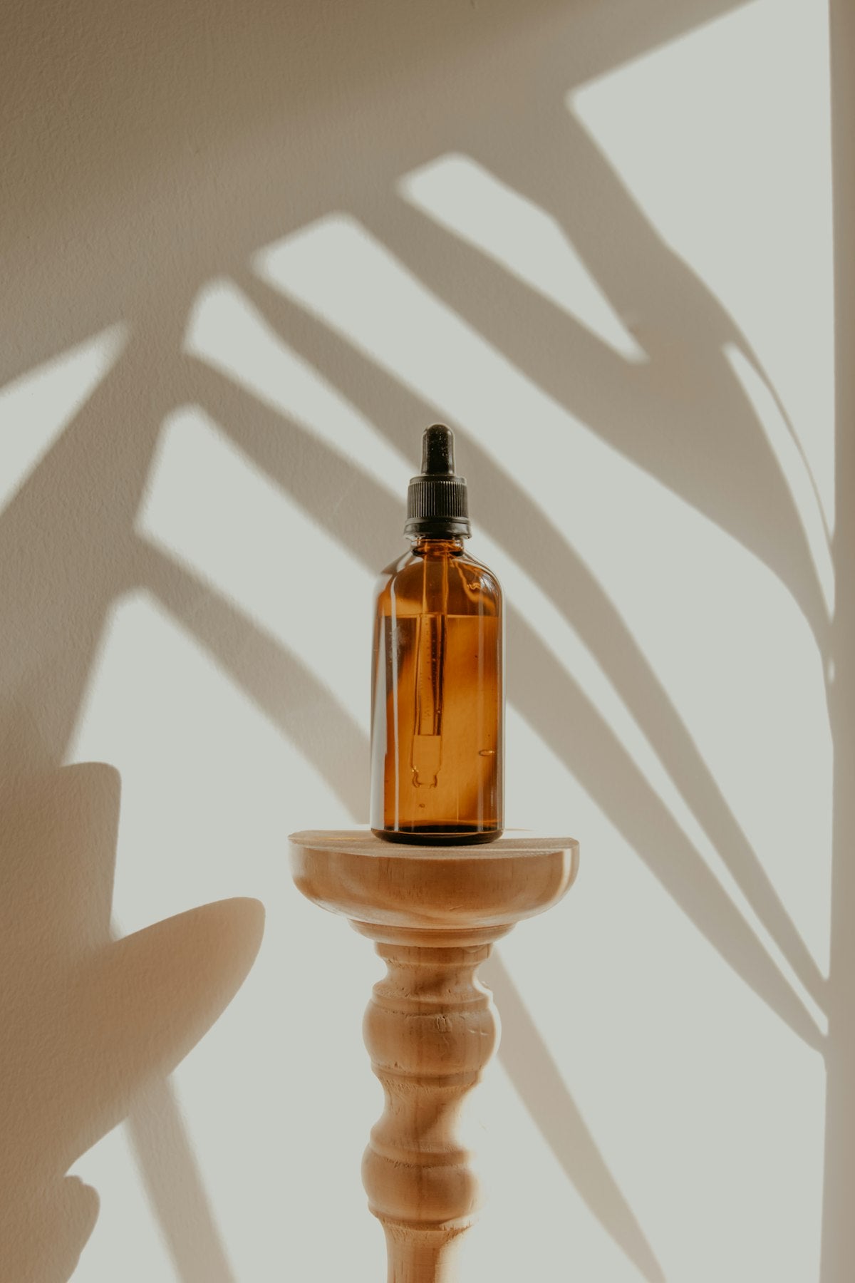 Six essential oil bottles arranged on a wooden surface